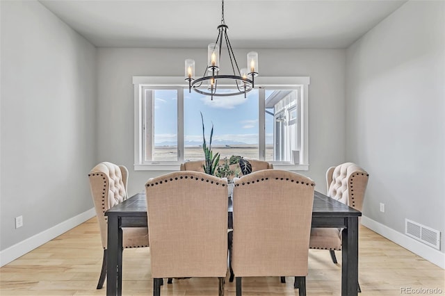 7668 Buckskin Ranch Vw, Peyton, CO 80831 - dining area with baseboards, a chandelier, visible vents, and light wood-type flooring