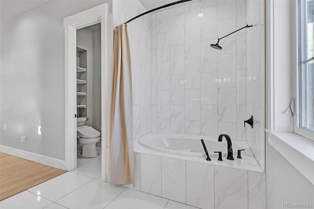 7668 Buckskin Ranch Vw, Peyton, CO 80831 - full bathroom featuring tiled shower / bath combo, tile patterned flooring, toilet, and baseboards