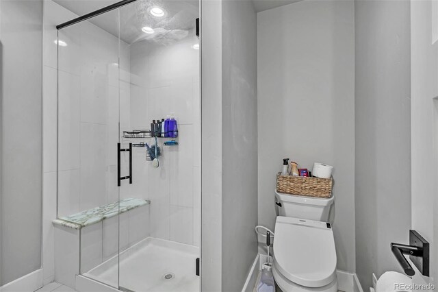 7668 Buckskin Ranch Vw, Peyton, CO 80831 - full bathroom featuring a stall shower, baseboards, and toilet