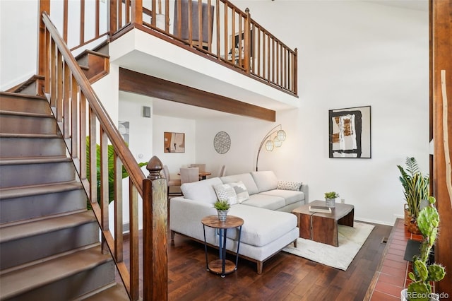 living room with a high ceiling and dark hardwood / wood-style flooring