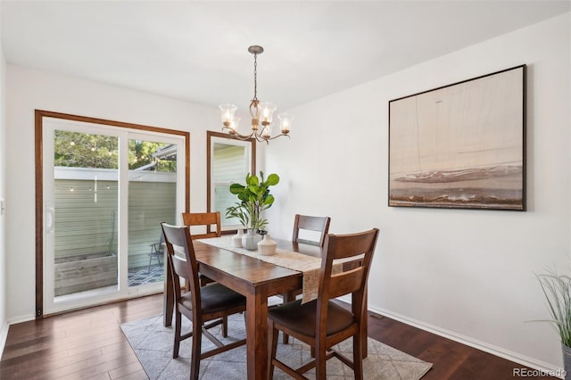 dining area featuring a chandelier and dark hardwood / wood-style floors