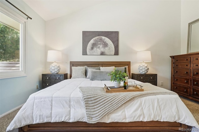 bedroom featuring carpet and vaulted ceiling