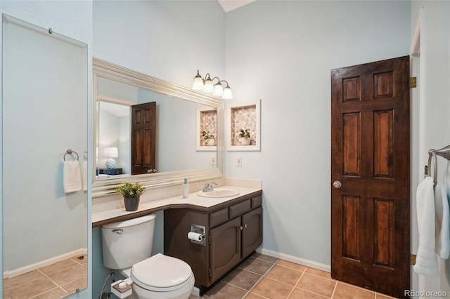 bathroom featuring toilet, vanity, and tile patterned floors