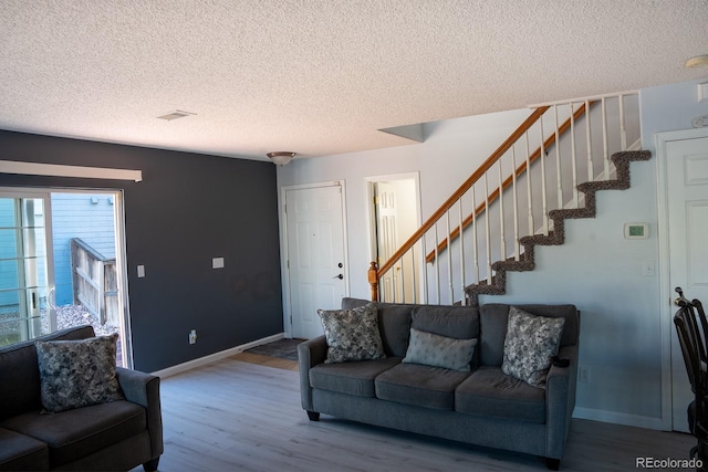 living room featuring hardwood / wood-style flooring and a textured ceiling