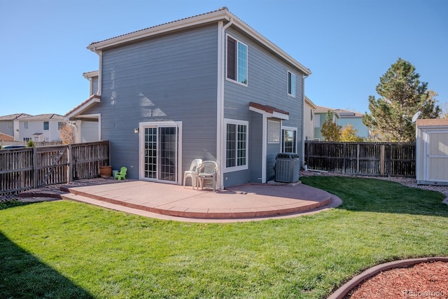 rear view of house featuring a yard, cooling unit, and a patio area