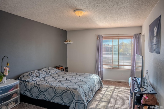 carpeted bedroom with a textured ceiling