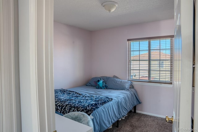 bedroom with carpet and a textured ceiling