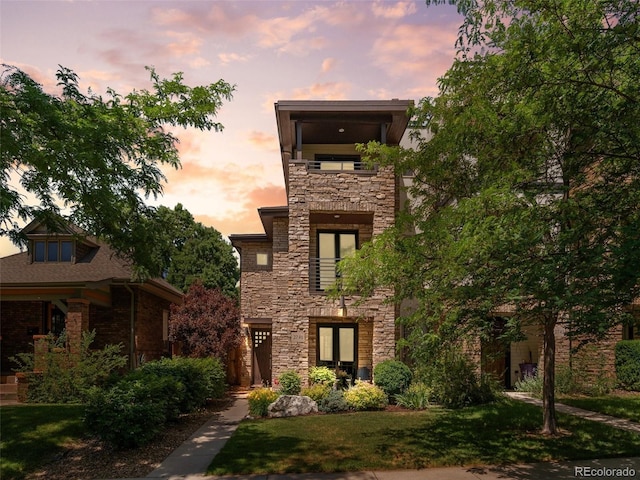 2741 Java Ct, Denver, CO 80211 - view of front of property with stone siding, a balcony, and a lawn