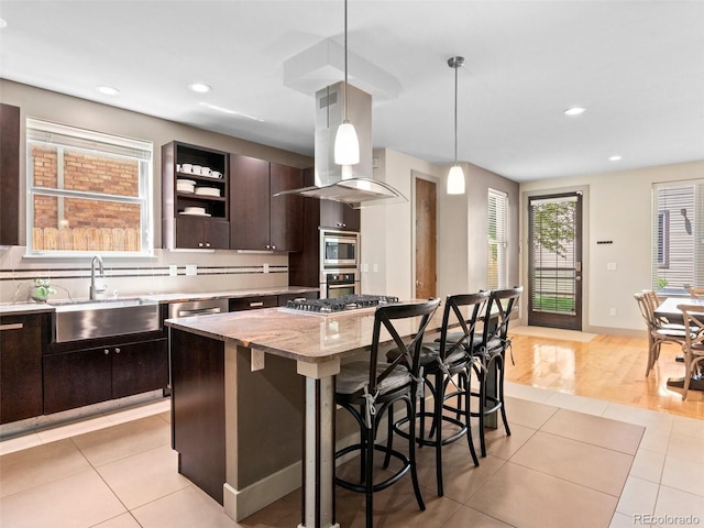 2741 Java Ct, Denver, CO 80211 - kitchen featuring a sink, appliances with stainless steel finishes, island range hood, dark brown cabinets, and light tile patterned flooring