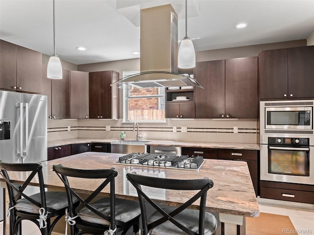 2741 Java Ct, Denver, CO 80211 - kitchen featuring stainless steel appliances, island exhaust hood, a breakfast bar, dark brown cabinetry, and decorative light fixtures