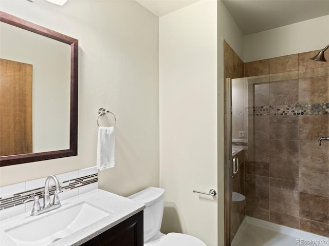 2741 Java Ct, Denver, CO 80211 - bathroom with vanity, a stall shower, toilet, and decorative backsplash