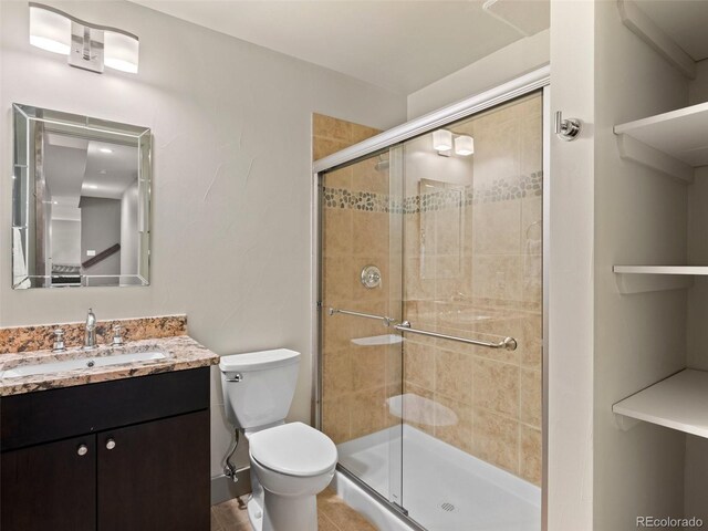 2741 Java Ct, Denver, CO 80211 - bathroom with a stall shower, toilet, vanity, and tile patterned floors