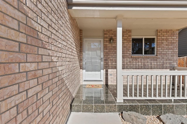 doorway to property with brick siding