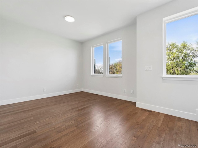 spare room with dark hardwood / wood-style flooring