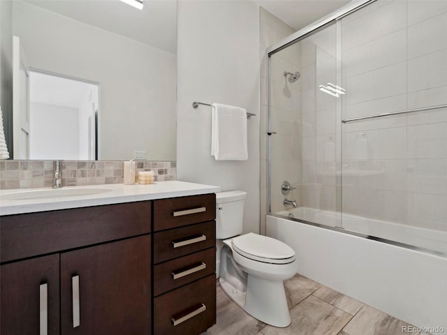 full bathroom with toilet, shower / bath combination with glass door, decorative backsplash, vanity, and hardwood / wood-style flooring