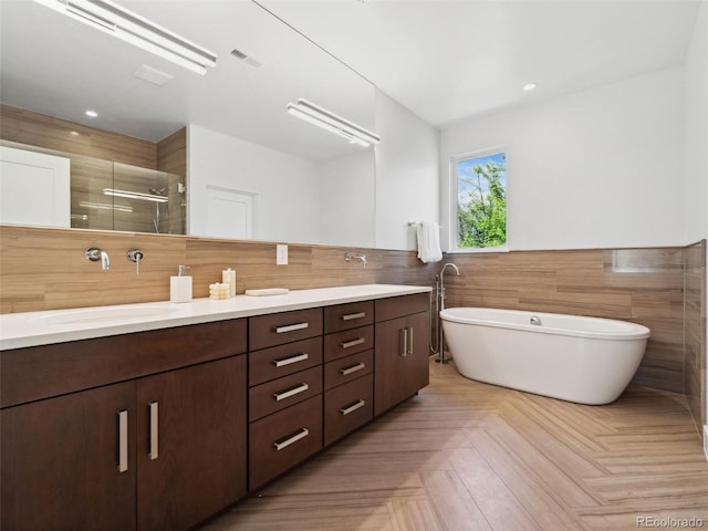 bathroom with parquet floors, plus walk in shower, and vanity