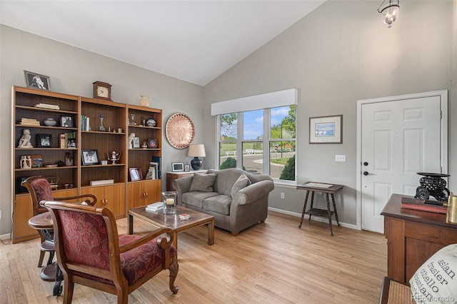 7696 S Hudson Way, Centennial, CO 80122 - living room with light wood finished floors, baseboards, and high vaulted ceiling