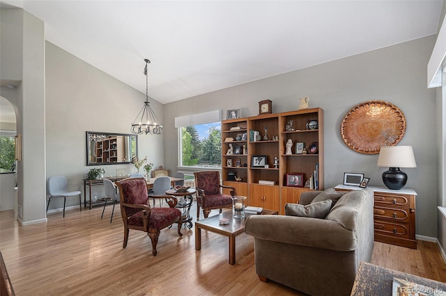 7696 S Hudson Way, Centennial, CO 80122 - living area with light wood finished floors, arched walkways, baseboards, a chandelier, and high vaulted ceiling