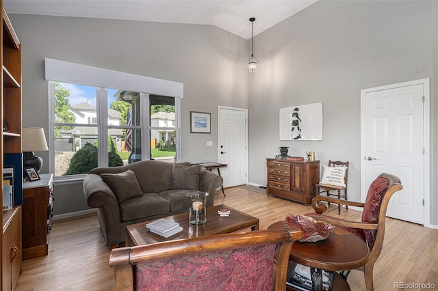 7696 S Hudson Way, Centennial, CO 80122 - living area with high vaulted ceiling, light wood-type flooring, and baseboards