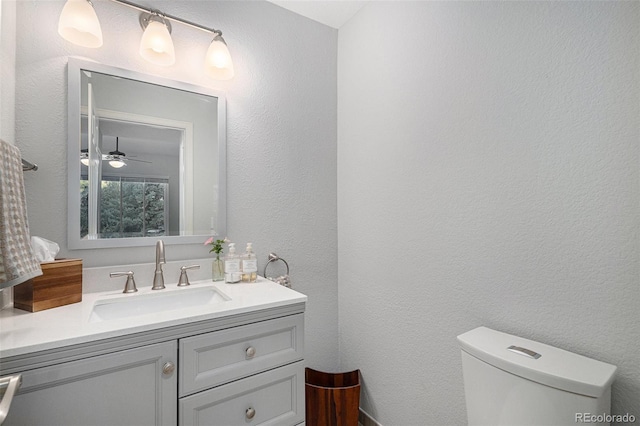 7696 S Hudson Way, Centennial, CO 80122 - half bathroom featuring vanity, toilet, a textured wall, and ceiling fan