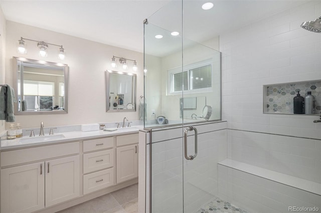 7696 S Hudson Way, Centennial, CO 80122 - bathroom featuring a shower stall, double vanity, tile patterned flooring, and recessed lighting