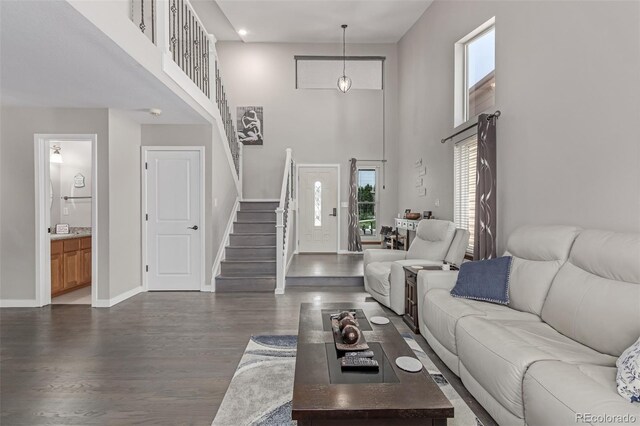 1371 W 133rd Way, Denver, CO 80234 - living room featuring stairs, a high ceiling, and dark wood-style floors