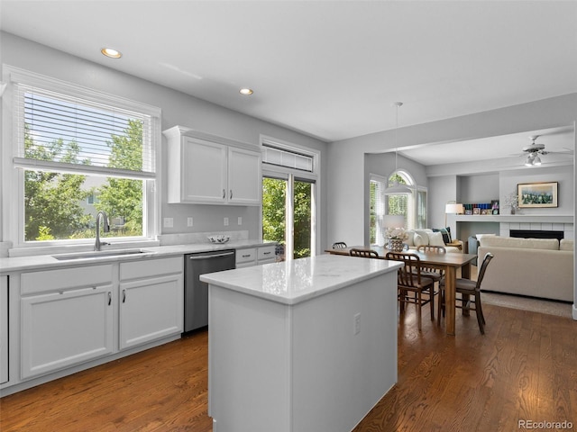 16362 Oakmoor Pl, Parker, CO 80134 - kitchen featuring dishwasher, dark wood-style flooring, white cabinetry, a center island, and open floor plan