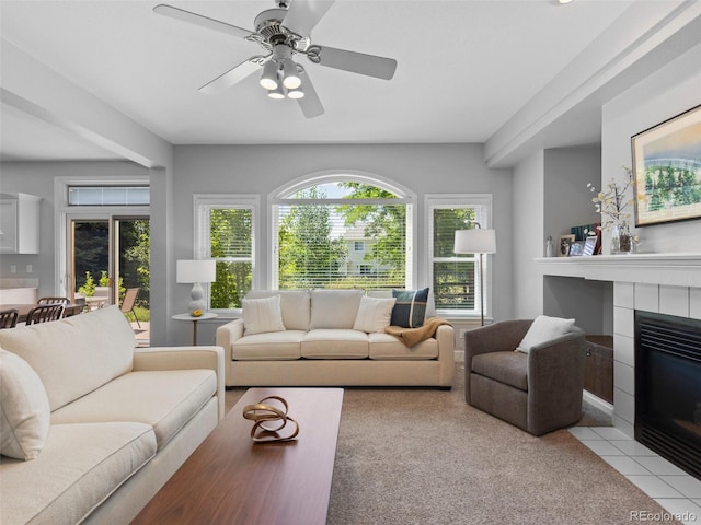 16362 Oakmoor Pl, Parker, CO 80134 - living area featuring a fireplace, ceiling fan, light tile patterned floors, and light carpet