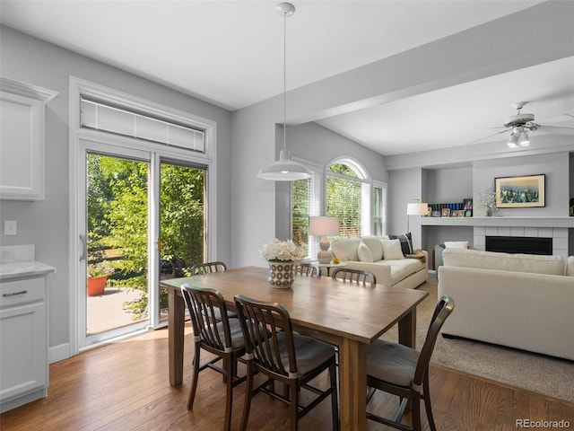 16362 Oakmoor Pl, Parker, CO 80134 - dining room with light wood-style flooring, a ceiling fan, a tile fireplace, and built in features