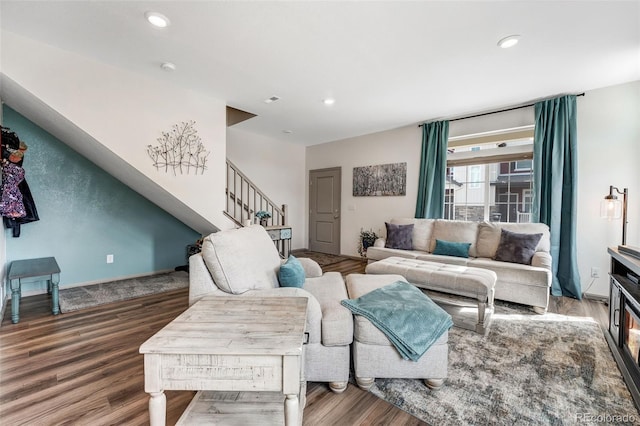 living room featuring stairs, recessed lighting, wood finished floors, and baseboards