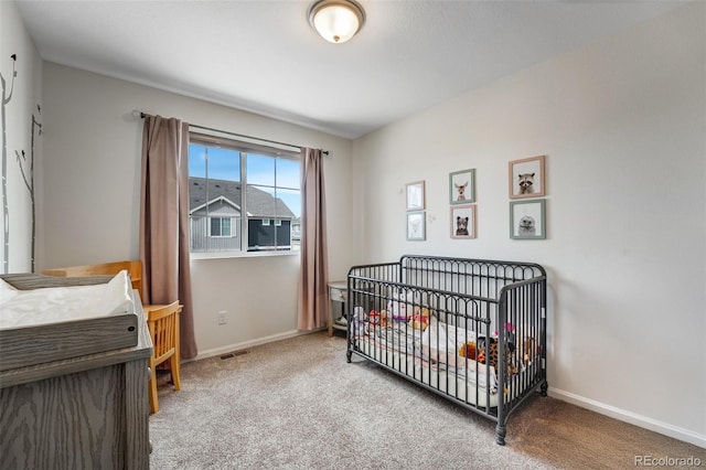 bedroom with visible vents, carpet floors, and baseboards