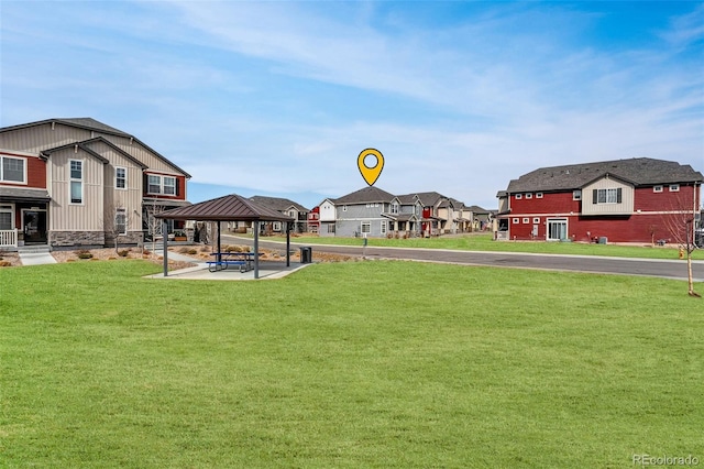 view of yard featuring a gazebo and a residential view