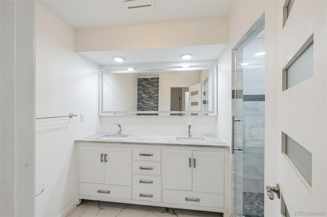 bathroom featuring tile patterned flooring, a shower with door, and vanity