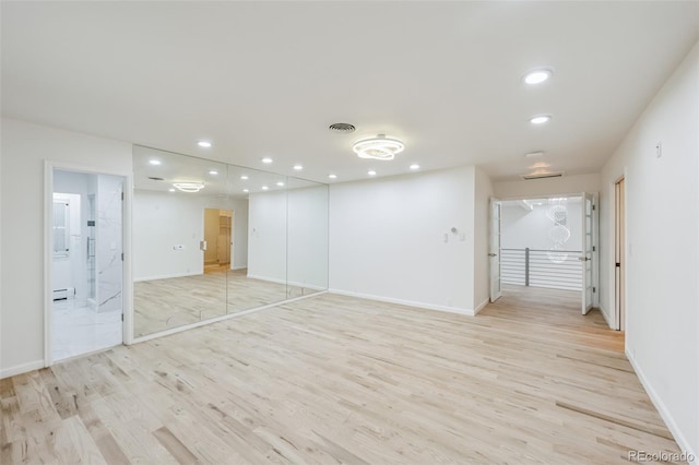 empty room featuring baseboards, recessed lighting, visible vents, and light wood-style floors