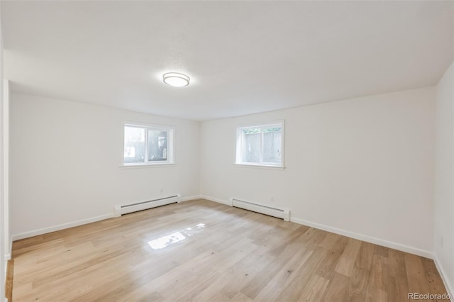 spare room featuring light hardwood / wood-style flooring and a baseboard heating unit