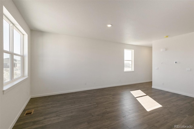 6721 Raven Ridge Ter, Colorado Springs, CO 80925 - unfurnished room featuring plenty of natural light, dark wood-style flooring, baseboards, and recessed lighting