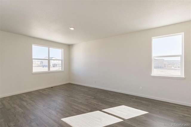 6721 Raven Ridge Ter, Colorado Springs, CO 80925 - empty room featuring dark wood-type flooring, baseboards, and recessed lighting
