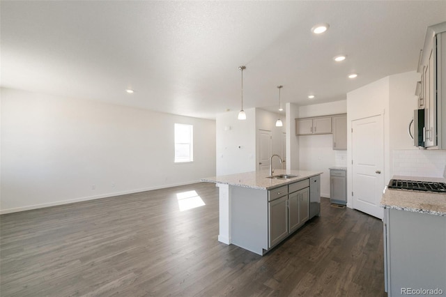 6721 Raven Ridge Ter, Colorado Springs, CO 80925 - kitchen featuring a sink, gray cabinetry, stainless steel microwave, dark wood-style floors, and backsplash