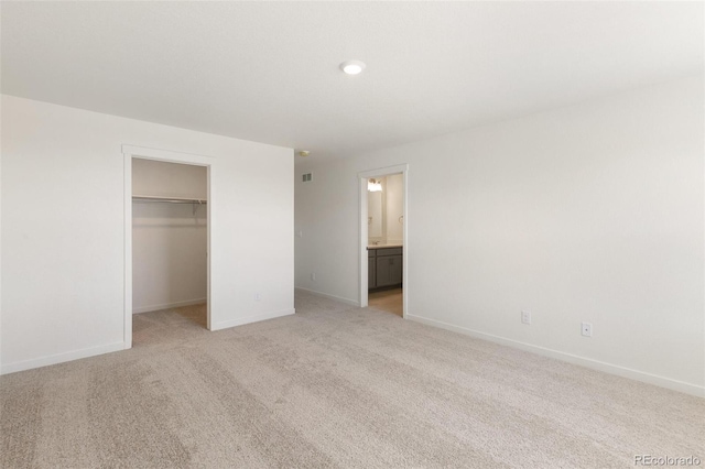 6721 Raven Ridge Ter, Colorado Springs, CO 80925 - unfurnished bedroom with a spacious closet, light colored carpet, baseboards, a closet, and recessed lighting