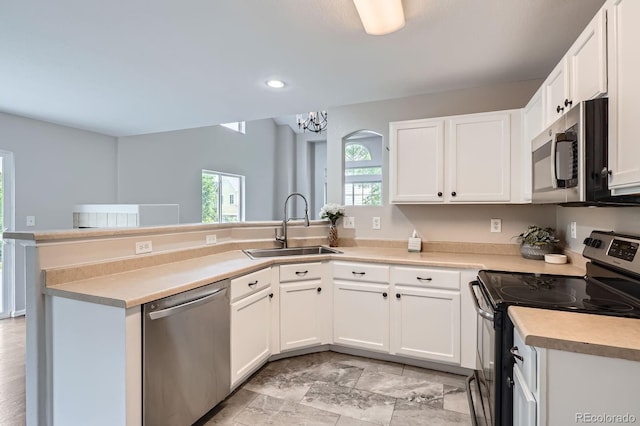 11029 Grouse Ct, Parker, CO 80134 - kitchen featuring appliances with stainless steel finishes, a peninsula, recessed lighting, and white cabinets