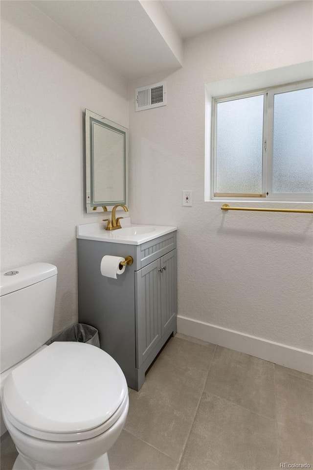 18396 E Mexico Pl, Aurora, CO 80017 - half bathroom with vanity, toilet, and baseboards