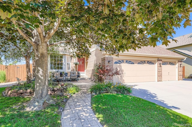 9733 Quay Loop, Broomfield, CO 80021 - view of property hidden behind natural elements with brick siding, concrete driveway, a garage, and a shingled roof
