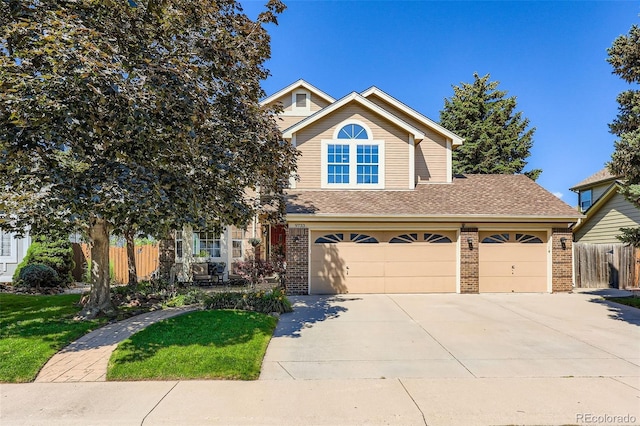 9733 Quay Loop, Broomfield, CO 80021 - view of front of home with brick siding, concrete driveway, roof with shingles, and an attached garage