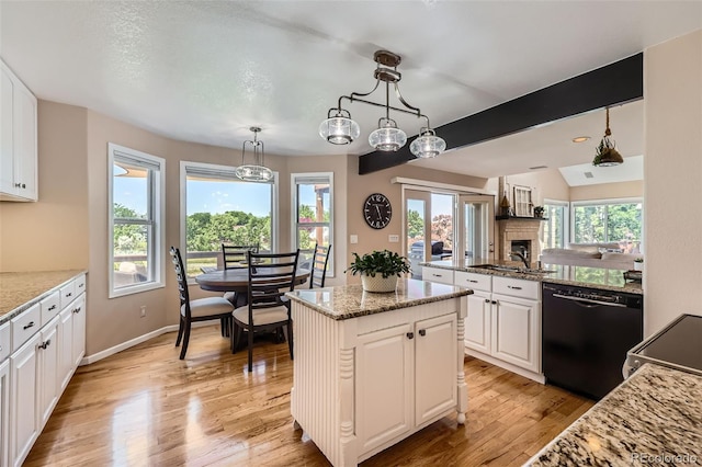 9733 Quay Loop, Broomfield, CO 80021 - kitchen featuring dishwasher, healthy amount of natural light, and white cabinets