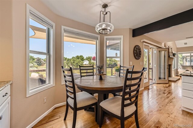 9733 Quay Loop, Broomfield, CO 80021 - dining space featuring light wood finished floors and beam ceiling