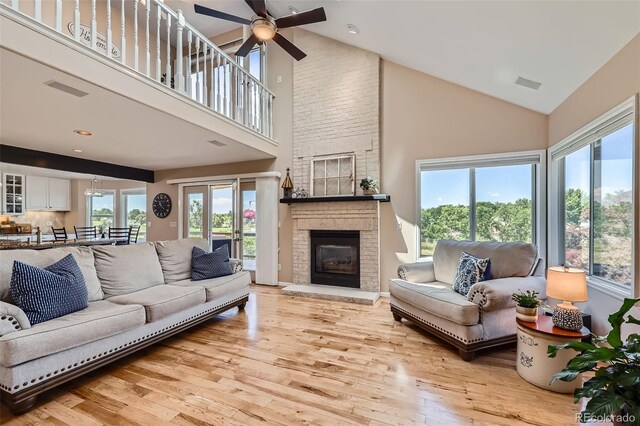 9733 Quay Loop, Broomfield, CO 80021 - living area featuring high vaulted ceiling, plenty of natural light, ceiling fan, and light wood-style floors