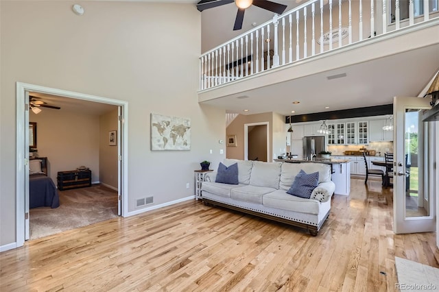 9733 Quay Loop, Broomfield, CO 80021 - living room with a ceiling fan, light wood-style flooring, and a high ceiling