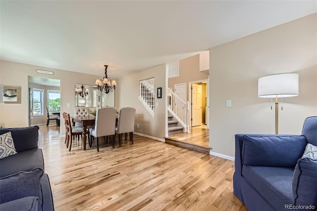 9733 Quay Loop, Broomfield, CO 80021 - living area with light wood finished floors, stairs, and a chandelier