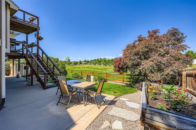 9733 Quay Loop, Broomfield, CO 80021 - view of patio / terrace with stairs, outdoor dining space, and a garden