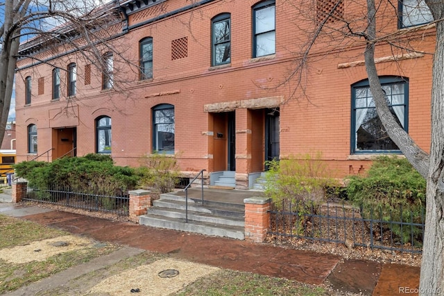 view of building exterior with fence
